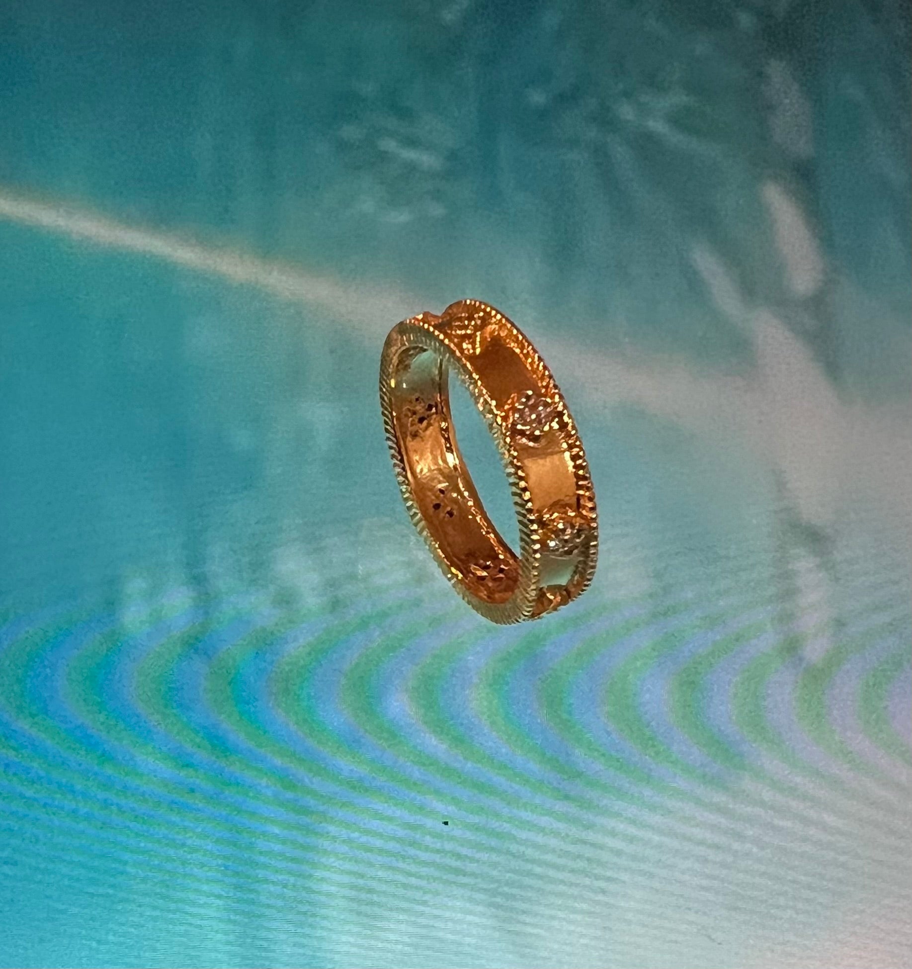 Floating Textured Gold Ring on Aqua Blue Background – Minimalist Jewelry Art